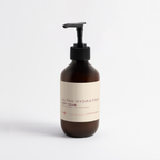 Brown bottle of ultra-hydrating body cream on a light gray background